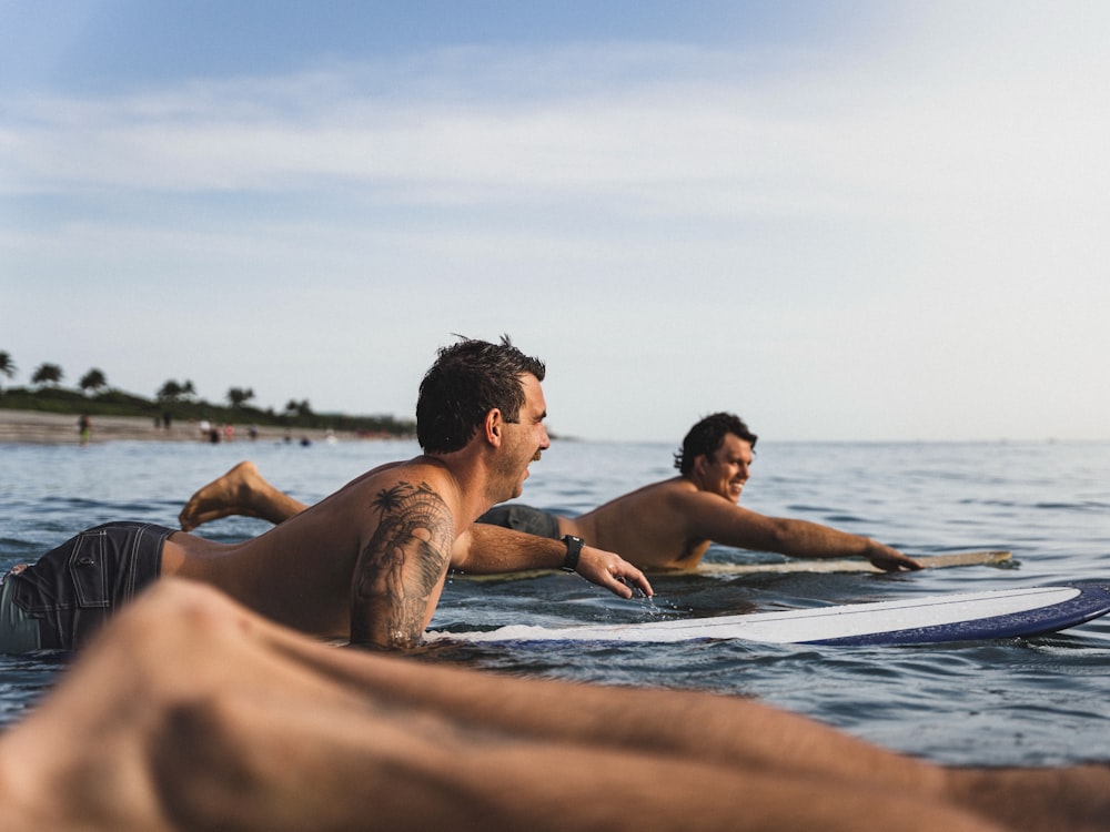 man and woman in water during daytime