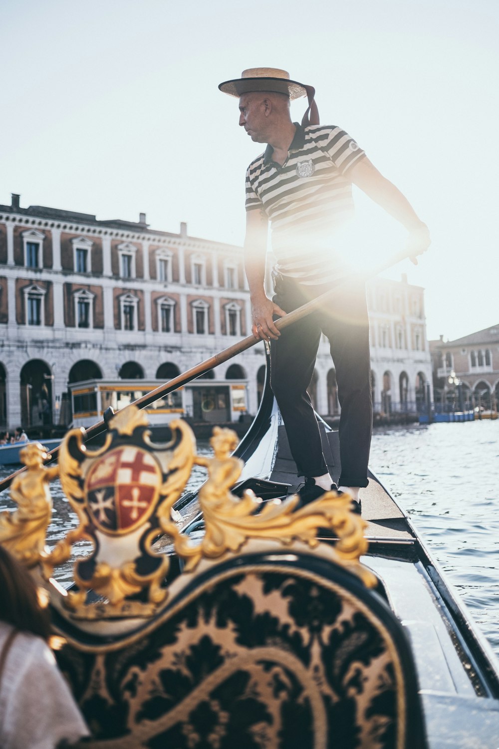 man in white shirt and black pants standing on boat during daytime