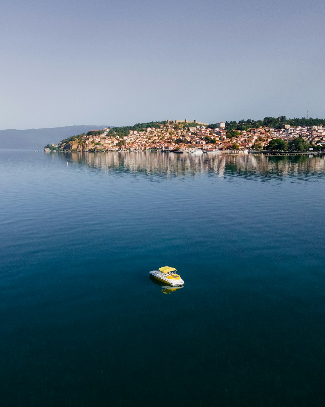yellow and white boat on blue sea water during daytime