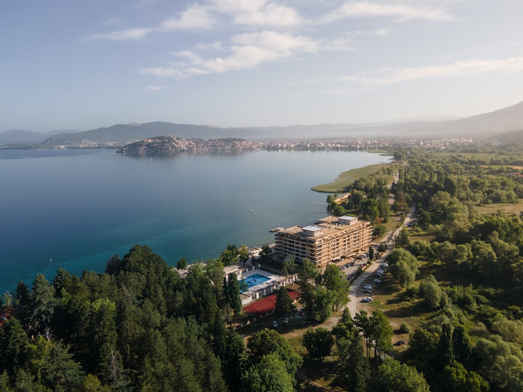 aerial view of city buildings near body of water during daytime