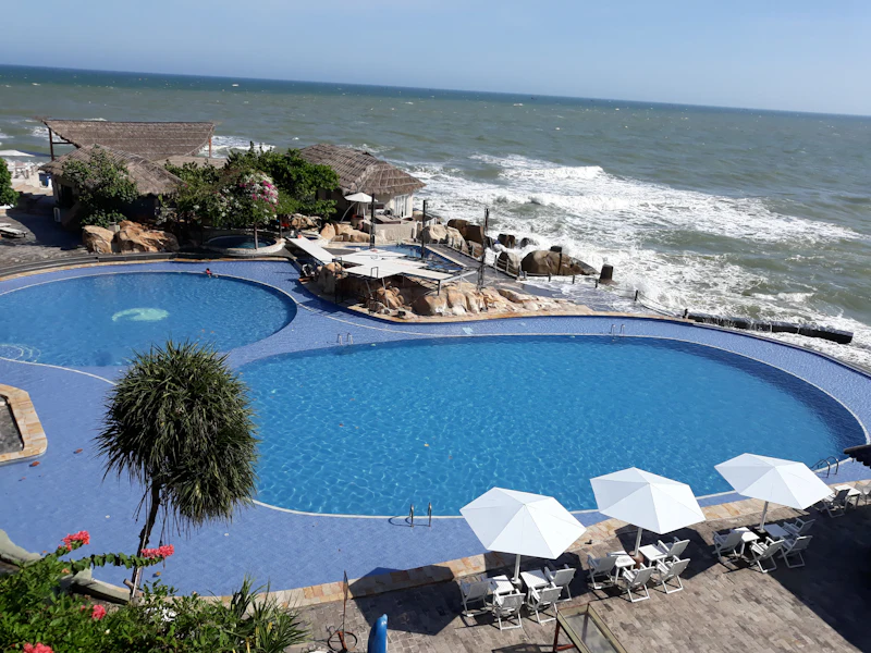 Resort pool surrounded by green gardens