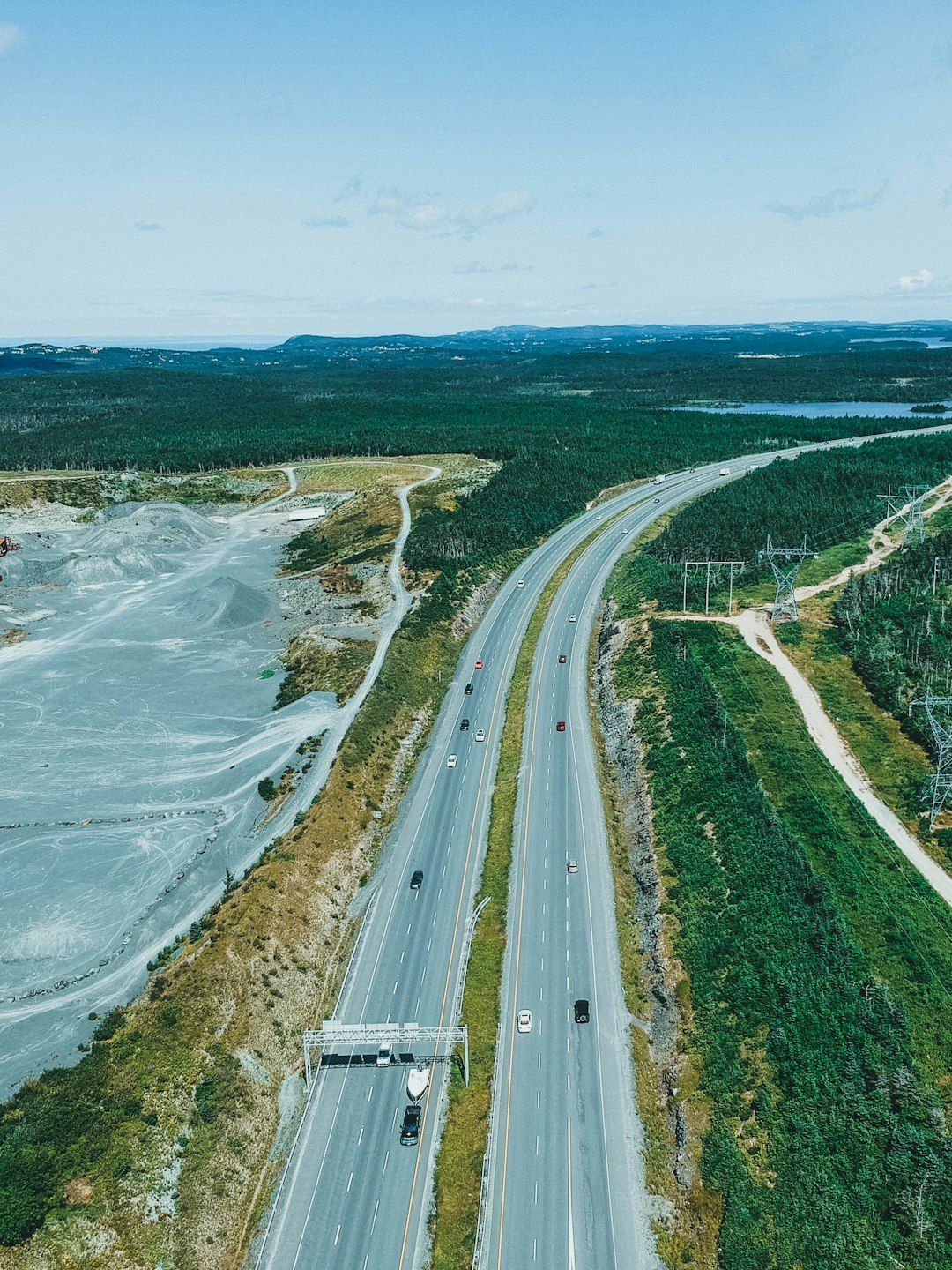 aerial view of road near body of water during daytime