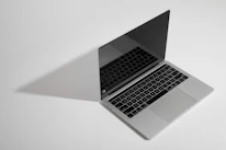 Close-up of a sleek laptop screen showing a minimalist website interface.