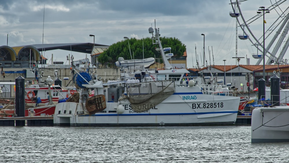 white and blue boat on sea during daytime