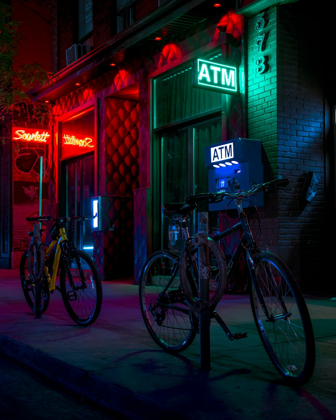 black commuter bike parked beside brown wooden building