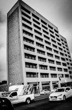 Modern office building with logistics operations and trucks in motion.