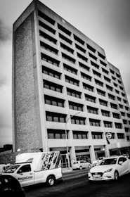 Modern commercial building with large windows and busy street view.