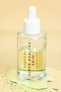clear glass bottle on white table