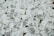 A large number of white cartons with black text saying 'Boxed Water is Better' are piled together. The cartons have graphics and text promoting sustainability.