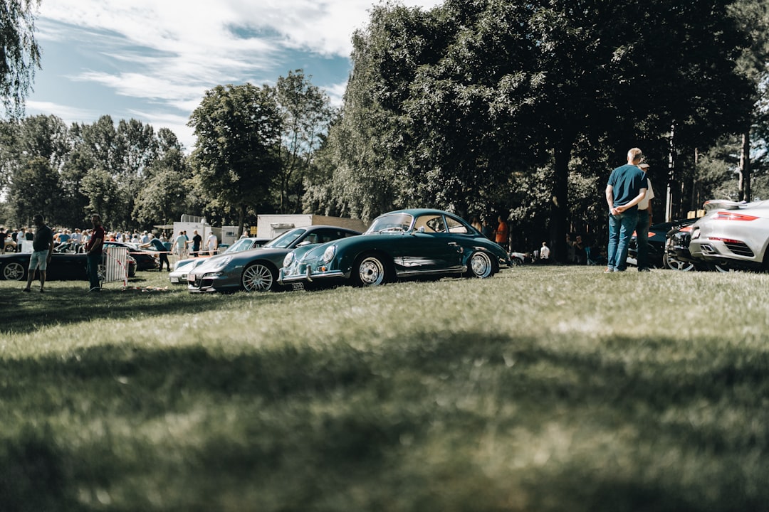 black coupe on green grass field during daytime