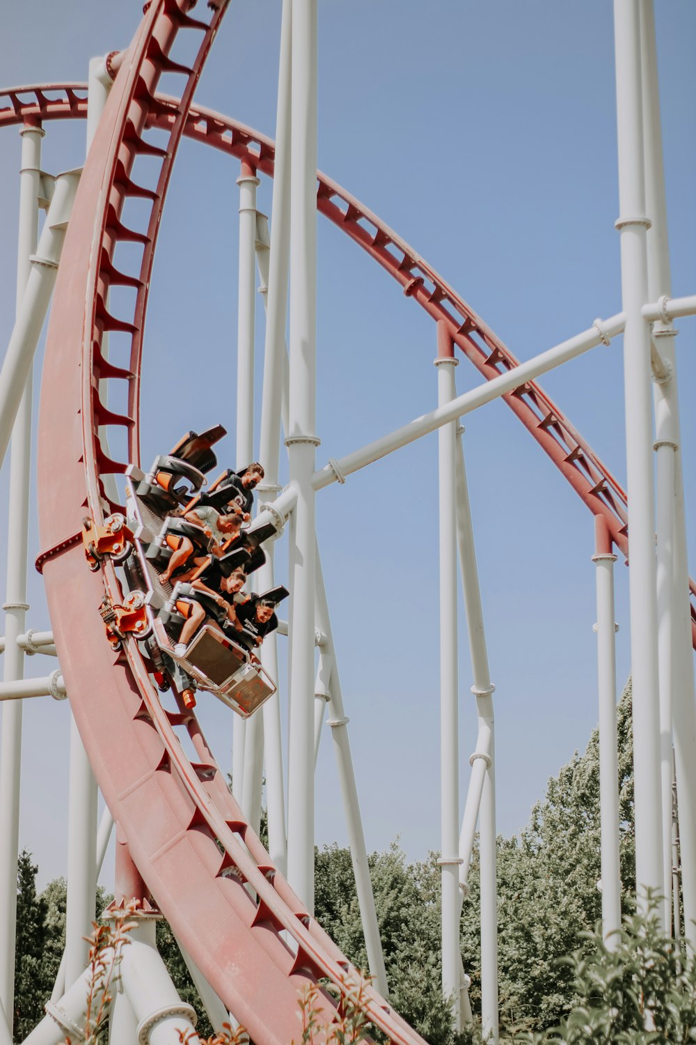 people riding roller coaster during daytime