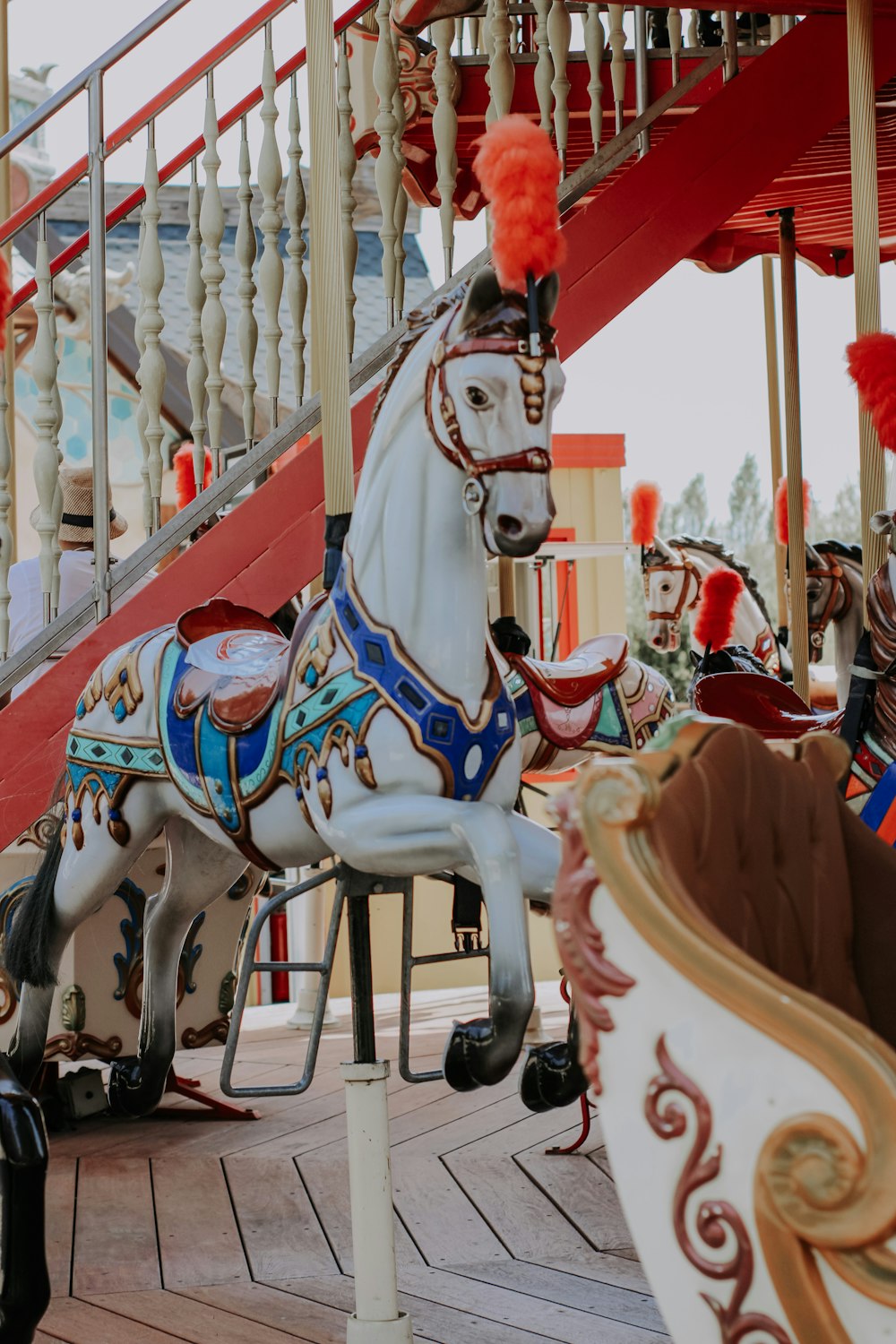 white and brown horse carousel