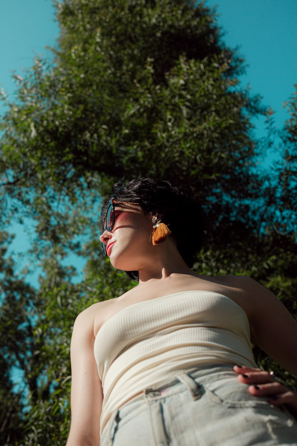 woman in white tank top wearing black sunglasses