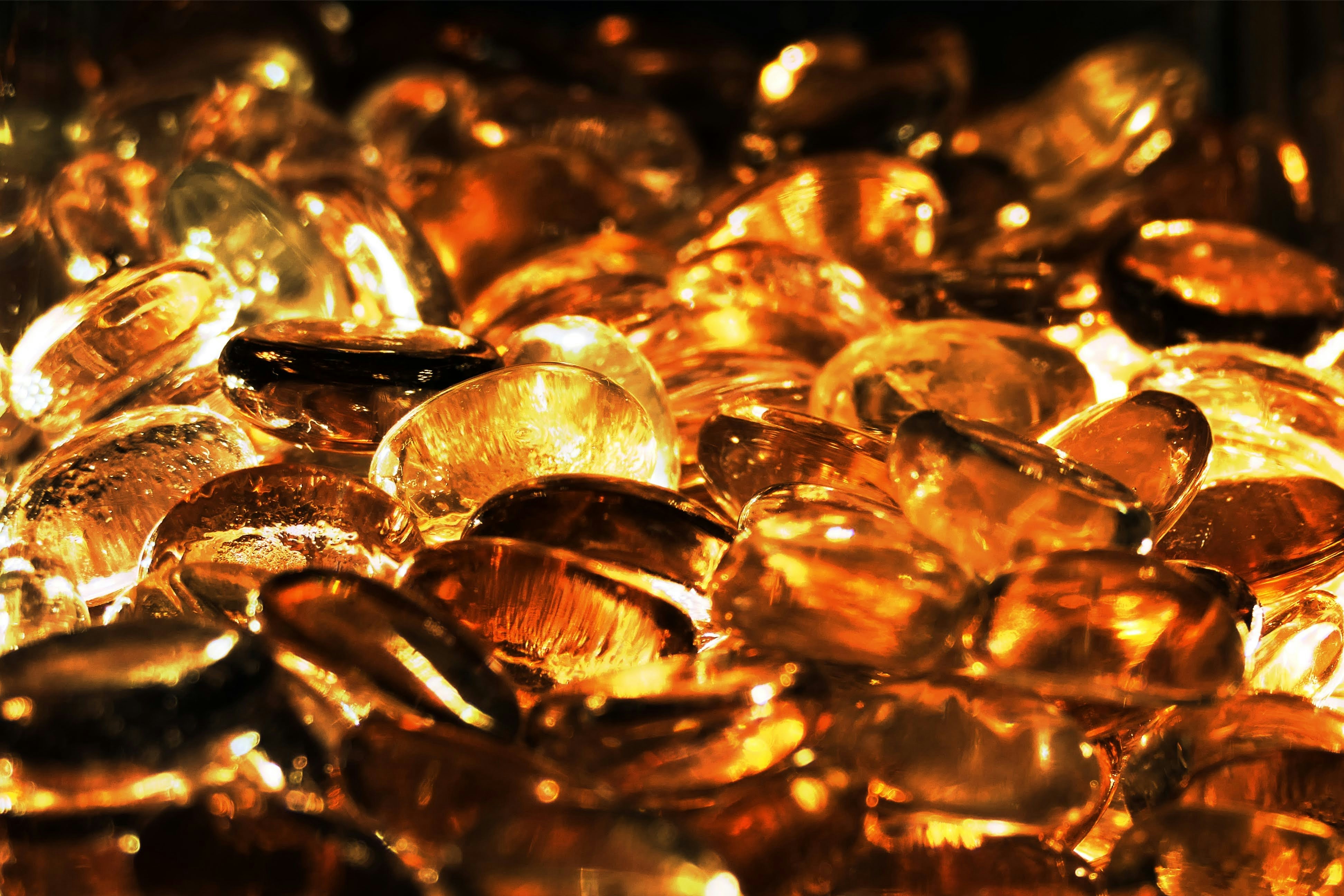 Close-up of amber bead, honey translucent color, white background