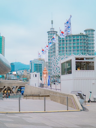 people walking on the street near white concrete building during daytime