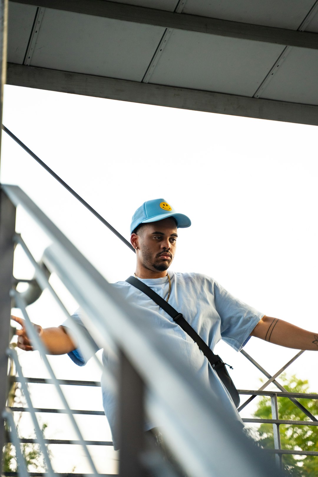 man in white button up shirt wearing blue cap