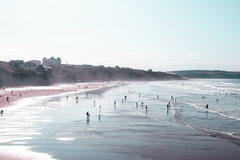 people surfing on sea waves during daytime