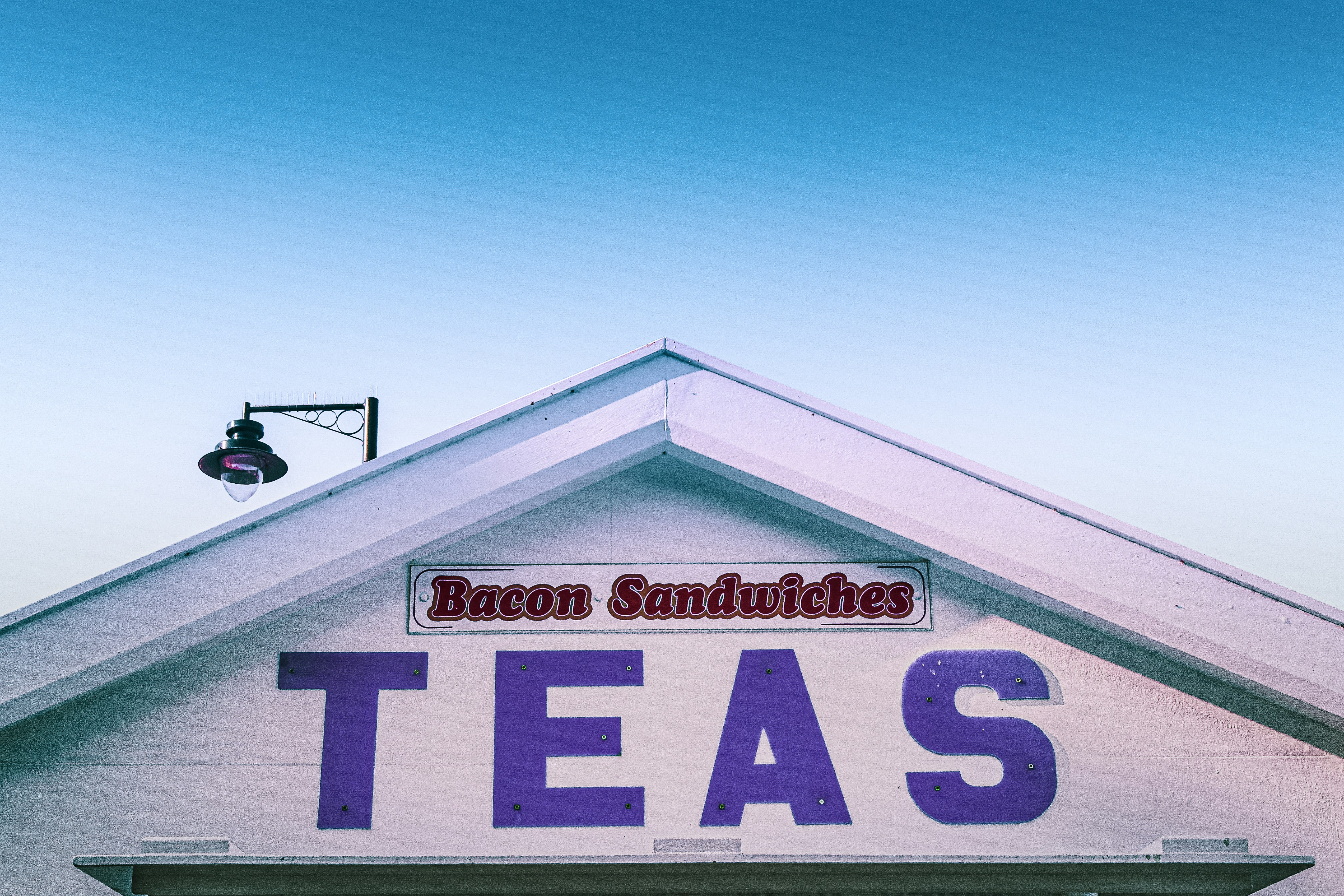 a building with a sign that says bacon sandwiches teas