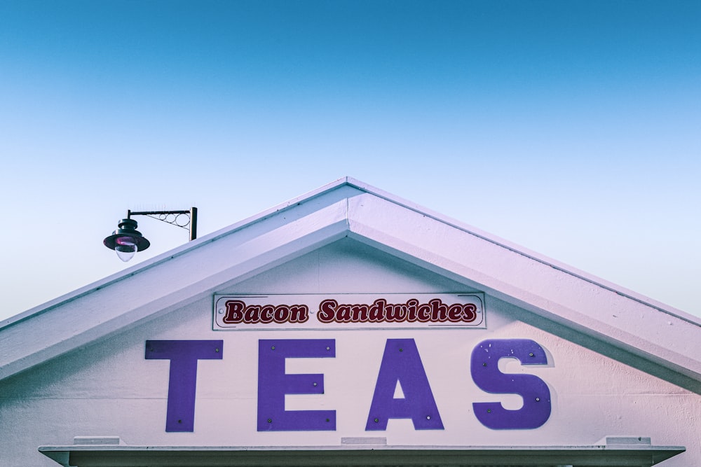 a building with a sign that says bacon sandwiches teas