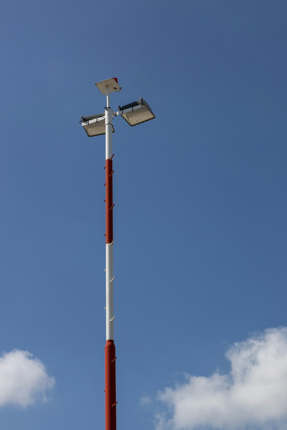 white and red metal tower under blue sky during daytime