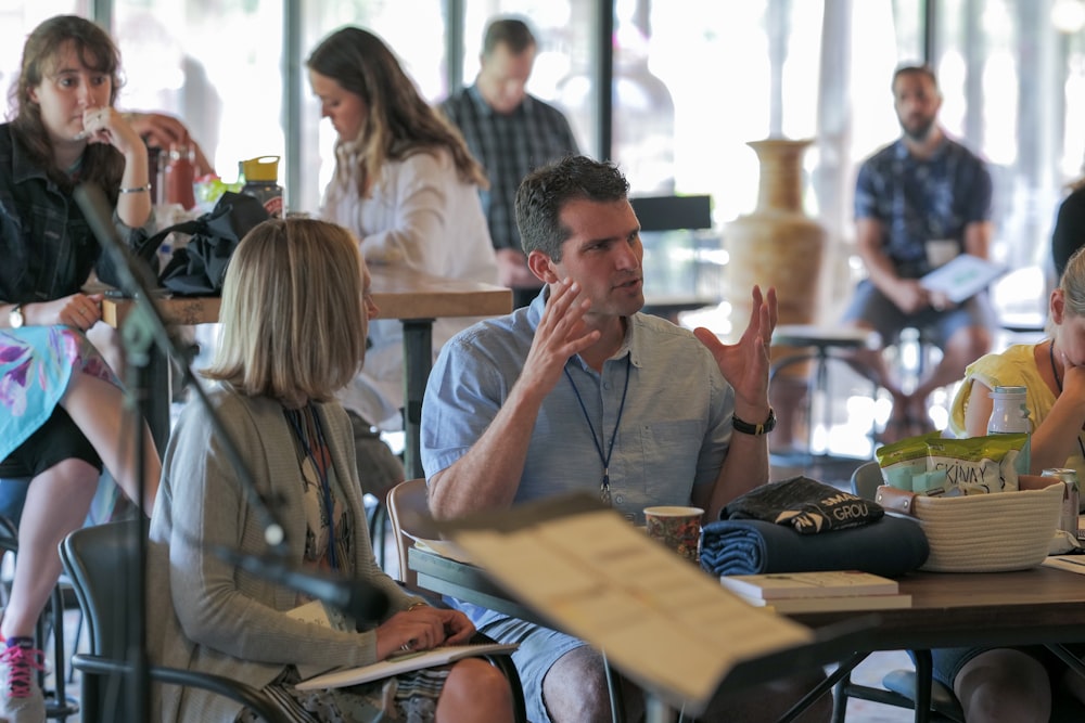 man in gray button up shirt sitting beside woman in gray shirt