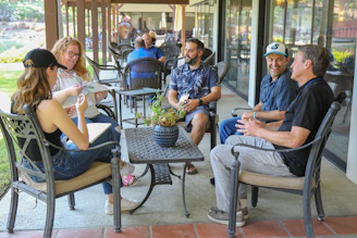 man in blue polo shirt sitting on black armchair