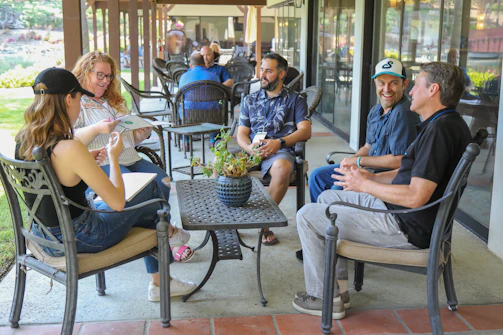 man in blue polo shirt sitting on black armchair