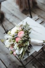 pink and white roses bouquet on white book page