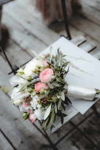 pink and white roses bouquet on white book page