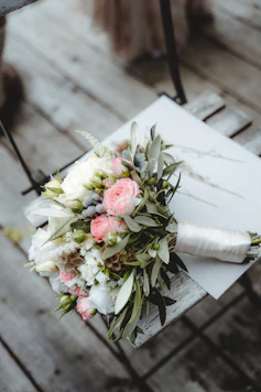 pink and white roses bouquet on white book page