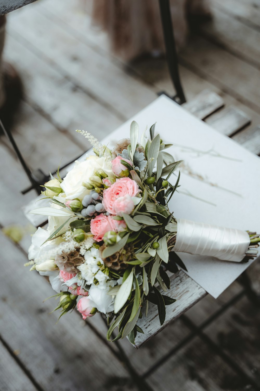 pink and white roses bouquet on white book page