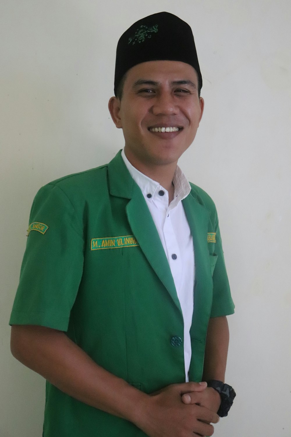 man in green polo shirt smiling