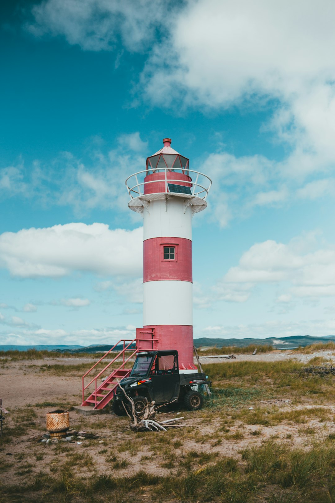 red and white lighthouse under blue sky during daytime