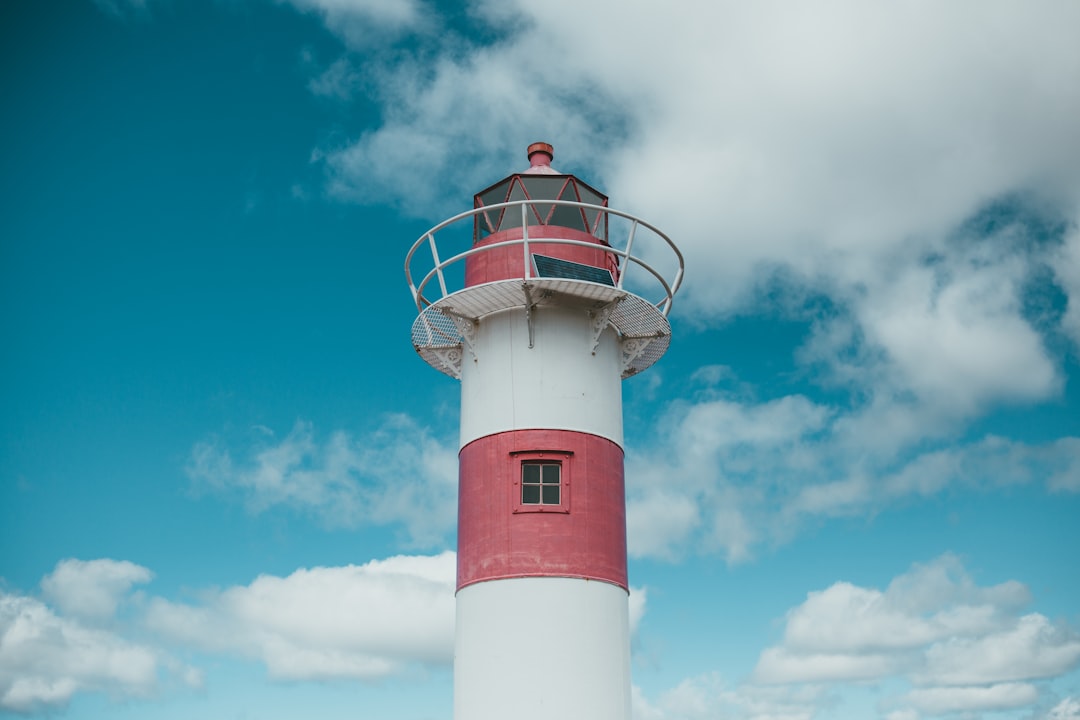 white and red lighthouse under blue sky during daytime