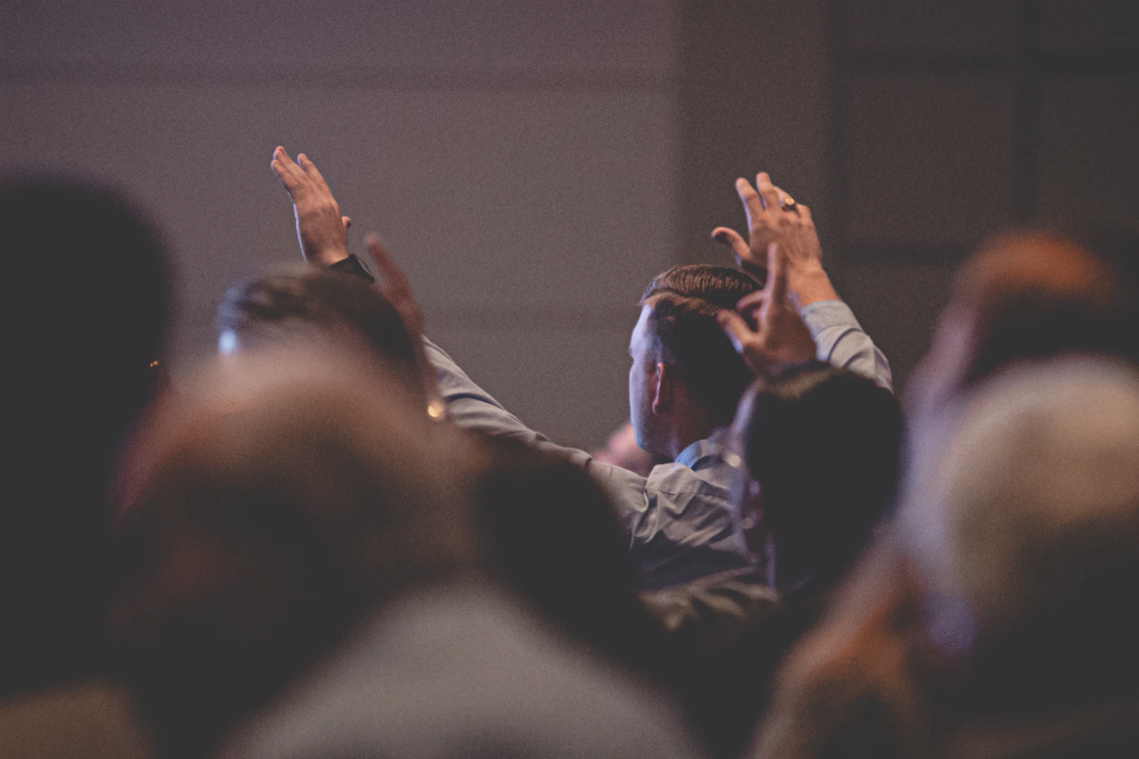 Hands raised in a conference hall