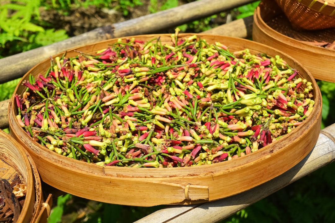 green and pink leaves on brown wooden round bowl