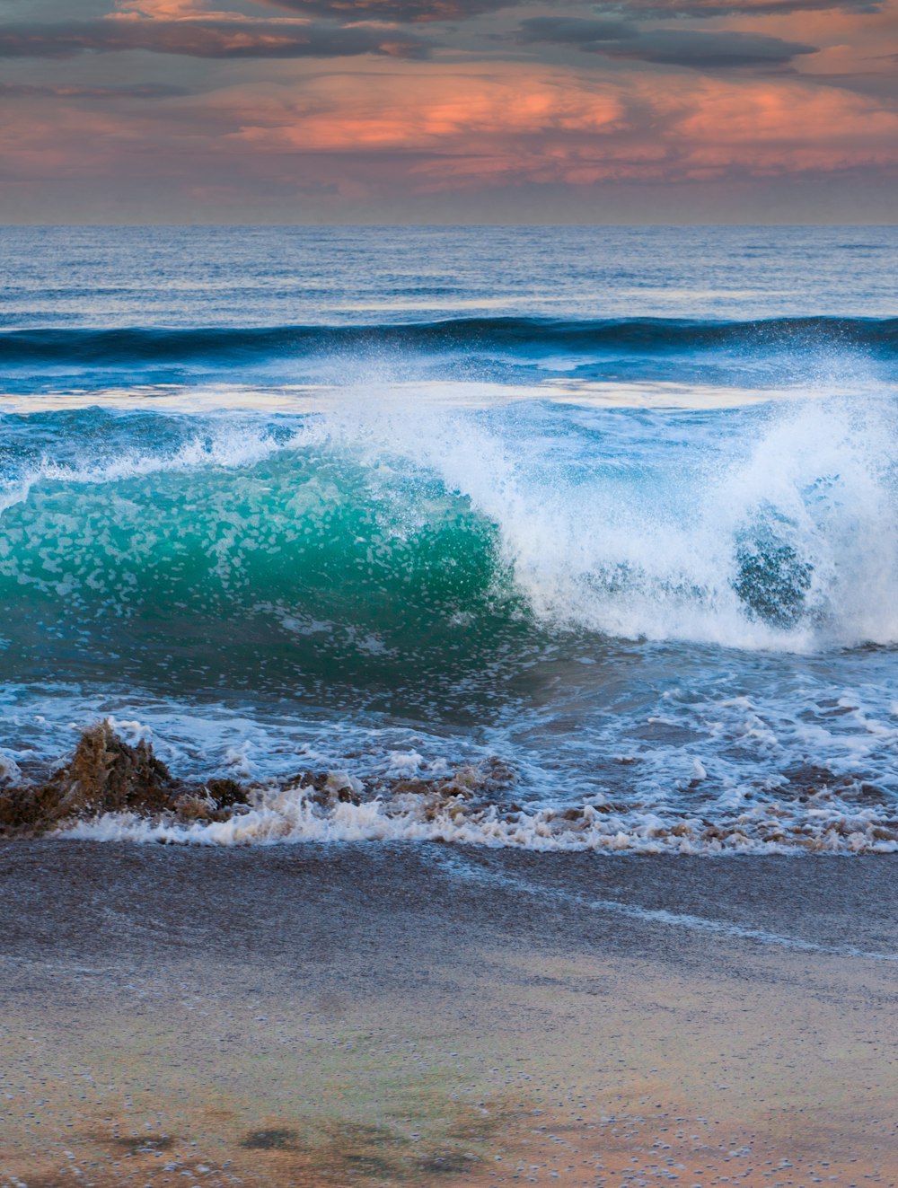 ocean waves crashing on shore during daytime