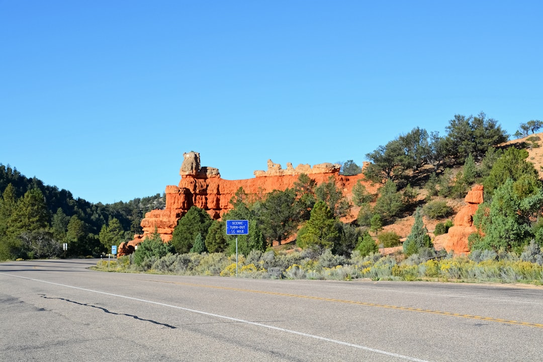 brown rock formation on the side of the road during daytime