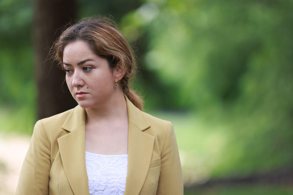 woman in brown blazer and white shirt