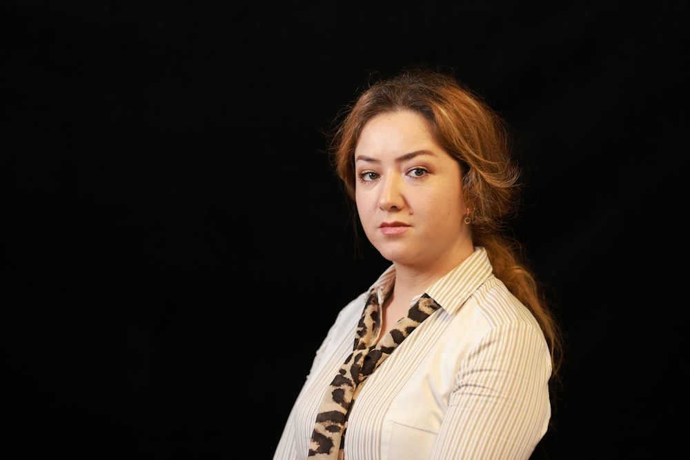 woman in white and black striped collared shirt