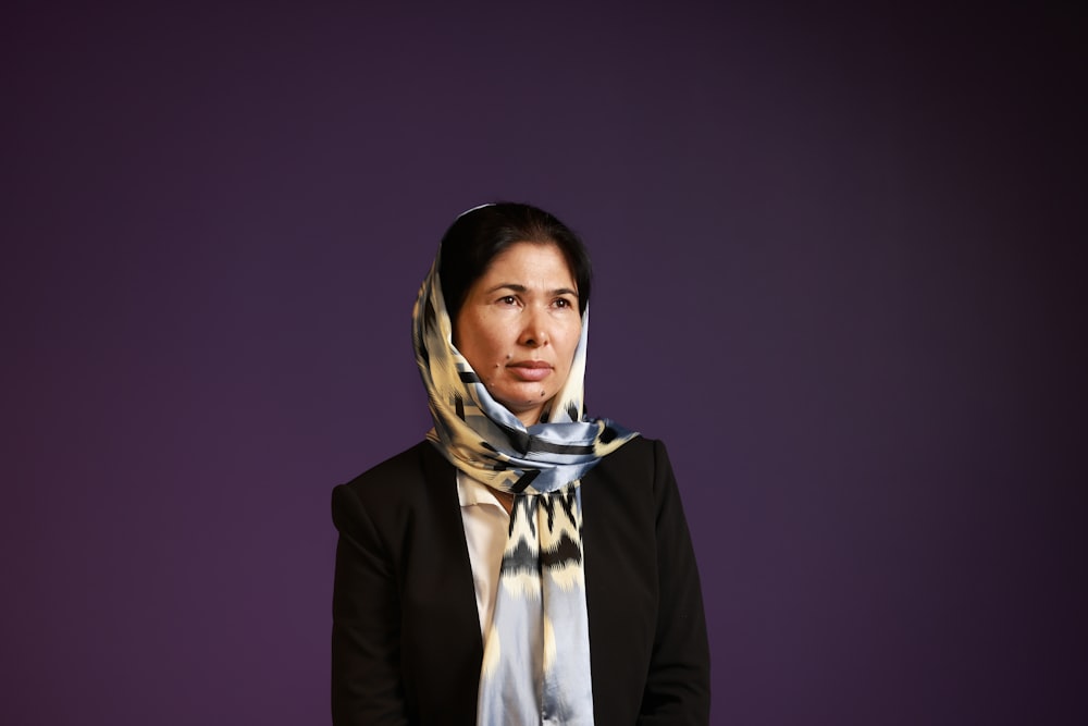 woman in black blazer and white and blue hijab