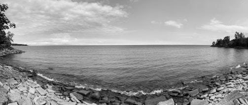 A serene watercolor scene of waves softly lapping against rocky shores.