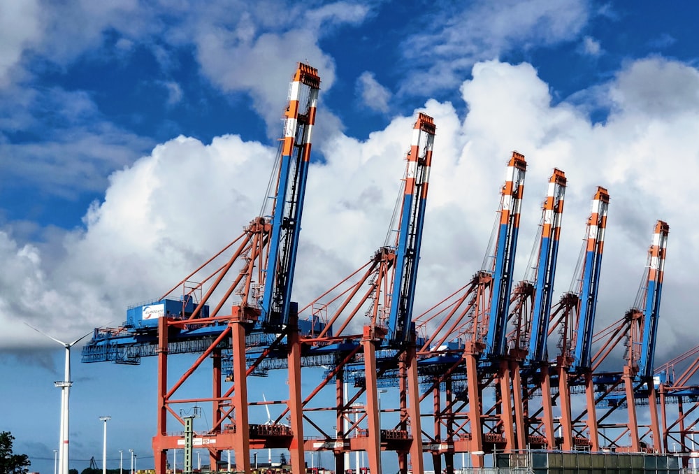 blue and orange metal crane under blue sky