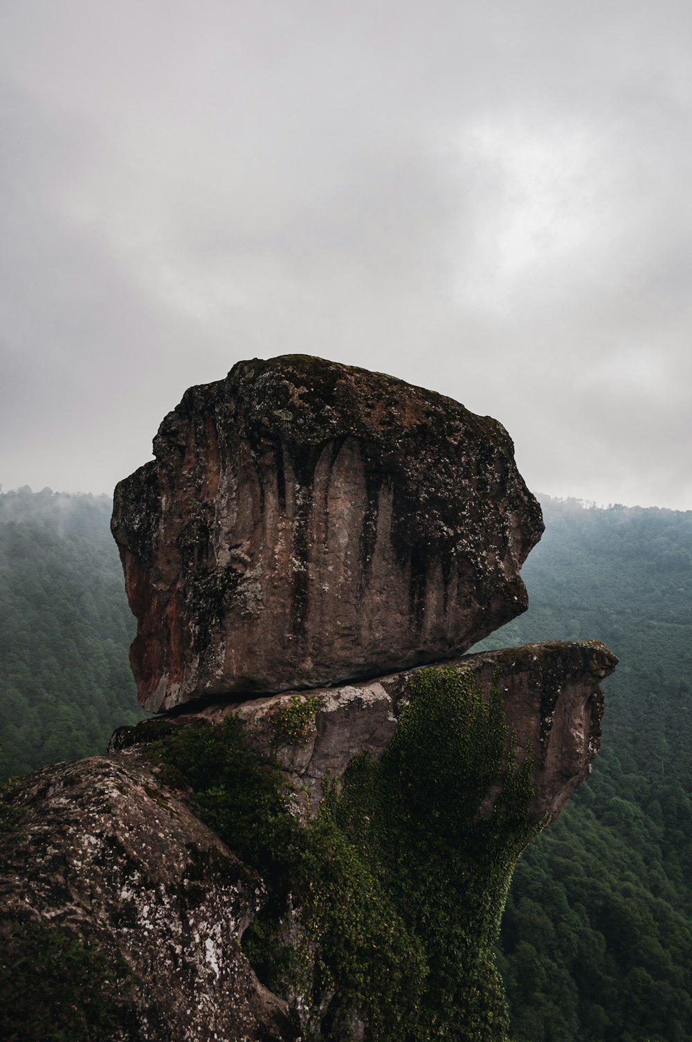 brown rock formation near body of water during daytime