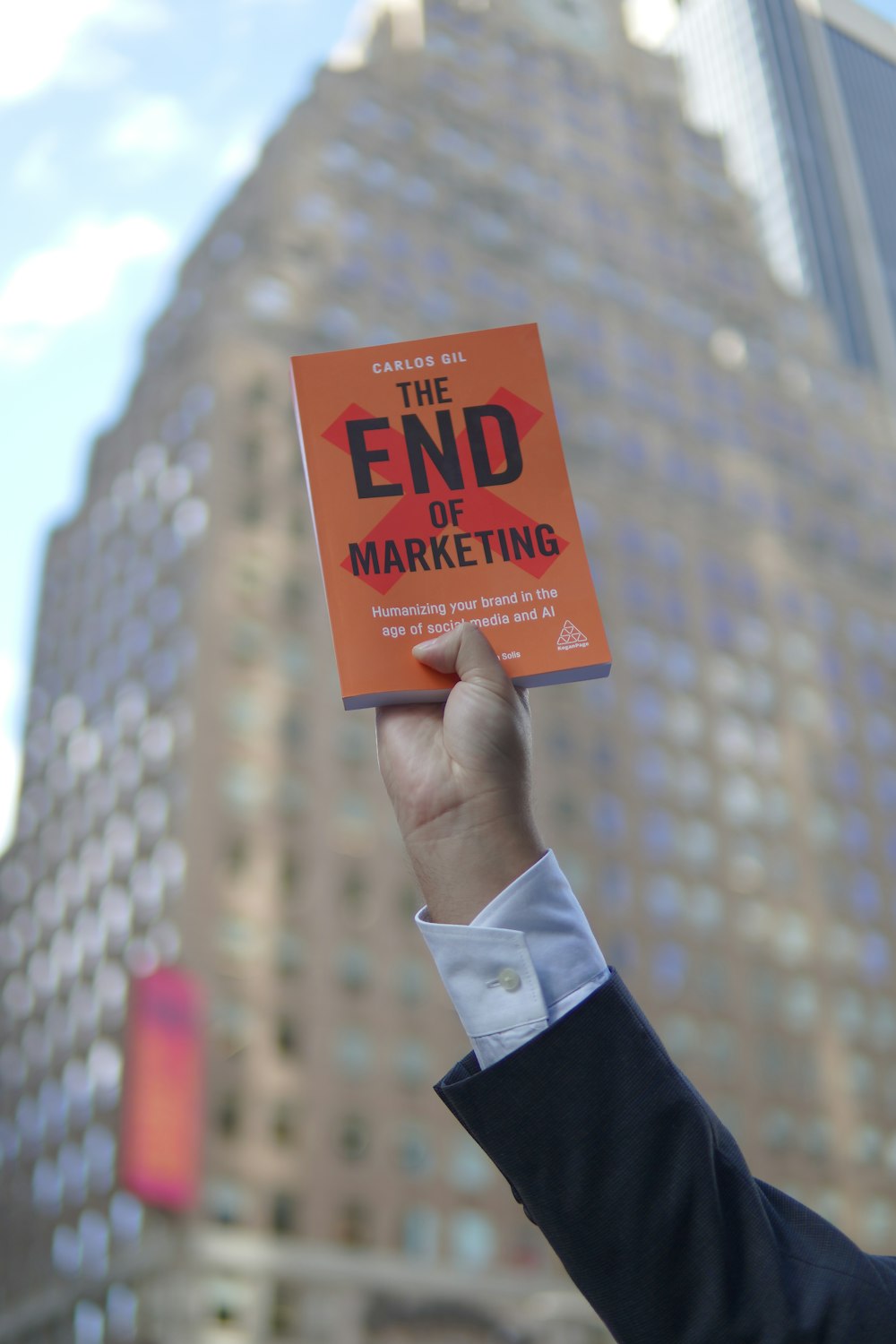 person holding orange and white box