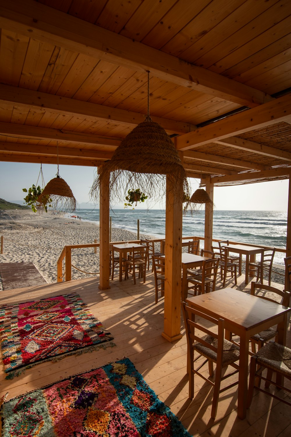 brown wooden table and chairs on beach during daytime