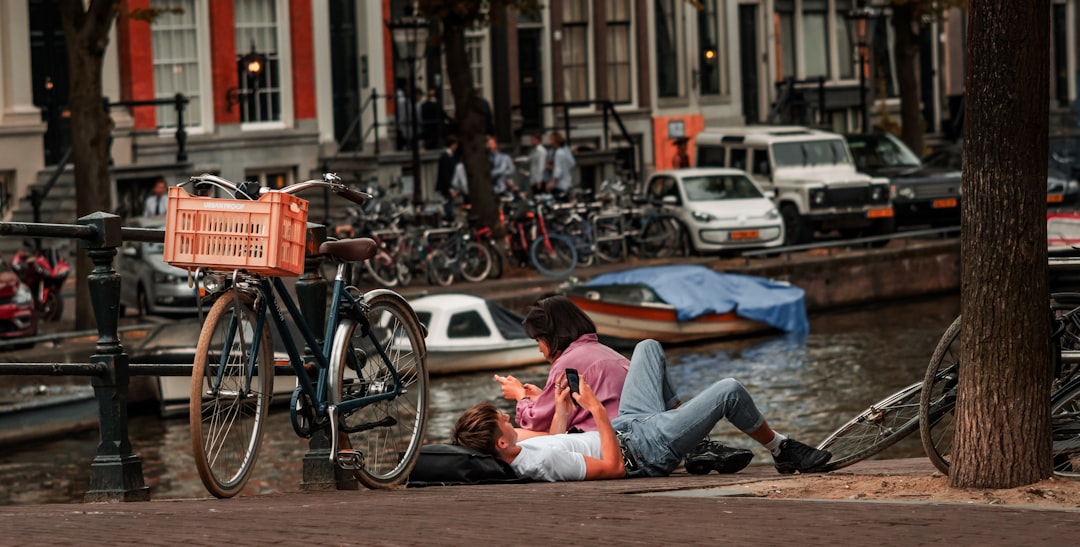 woman in pink long sleeve shirt lying on the ground