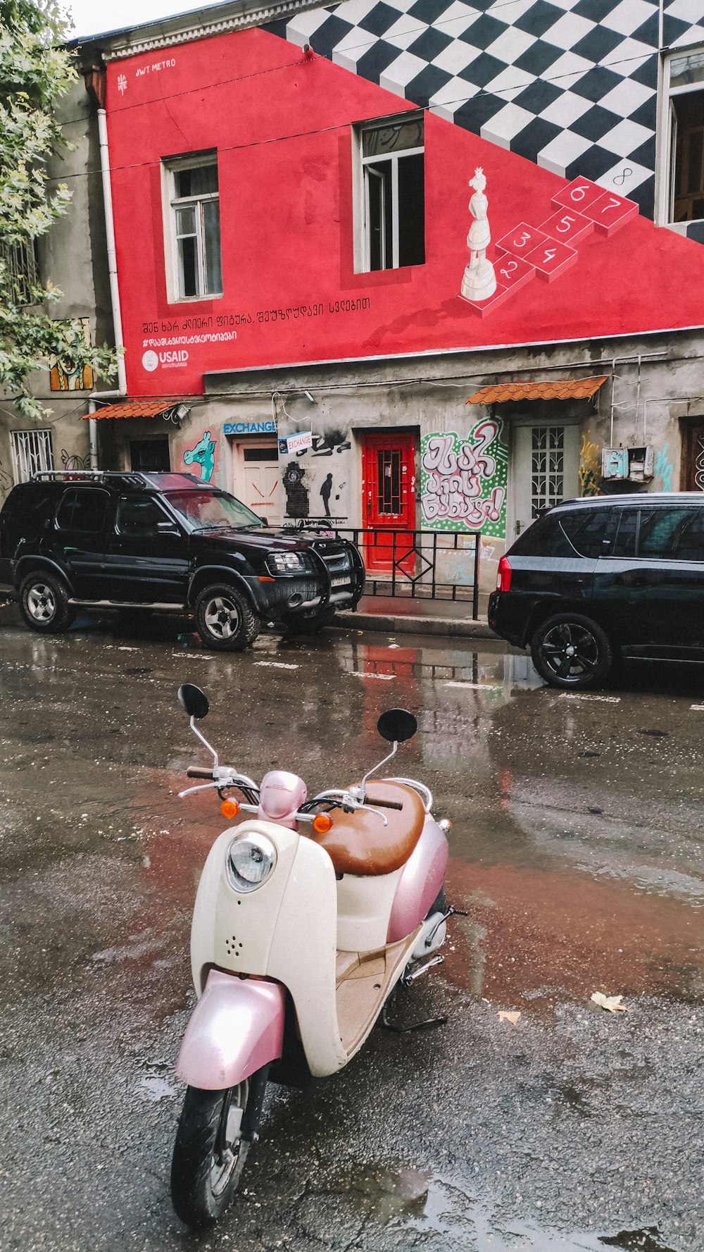 black suv parked beside red and white concrete building during daytime