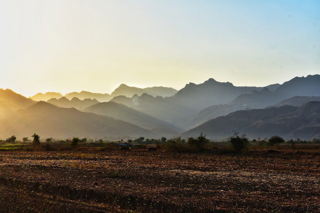 green grass field near mountains during daytime