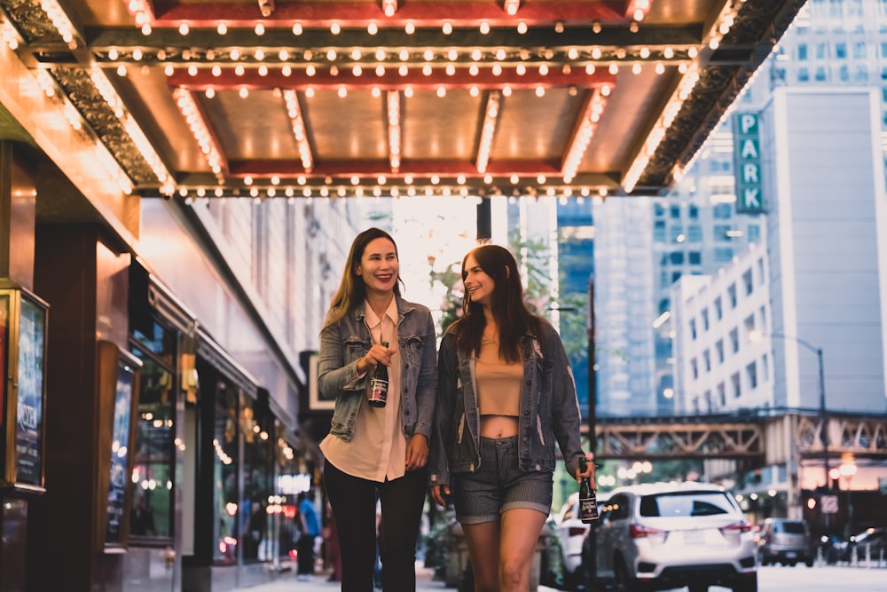 woman in black denim jacket standing beside woman in black jacket